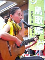 鳥取県の「蟹取県イベント」で歌うボサノバ歌手の結美さん＝２０１５年10月17日、大阪・京橋中央商店街