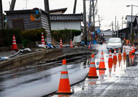 　能登半島地震による液状化被害が残る石川県内灘町西荒屋地区。道路の復旧工事が続く＝２２日午後