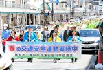 横断幕を掲げてパレードする関係者＝１１日、鳥取市の若桜街道