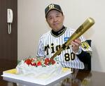 　６６歳の誕生日を迎え、ケーキとバットを手に笑顔の阪神・岡田監督＝甲子園