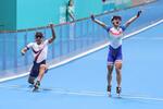 　ローラースケート男子スピード・３０００メートルリレー　左足を伸ばしてゴールした台湾のアンカー（左）に先着され、金メダルを逃した韓国選手＝２日、杭州（聯合＝共同）