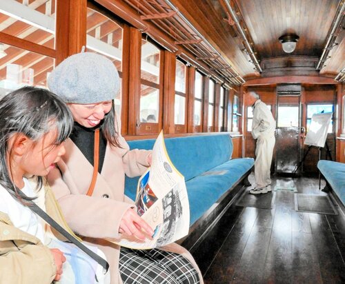 デハ２０３号に乗り込んで運行当時に思いをはせる家族連れ＝９日、南部町法勝寺