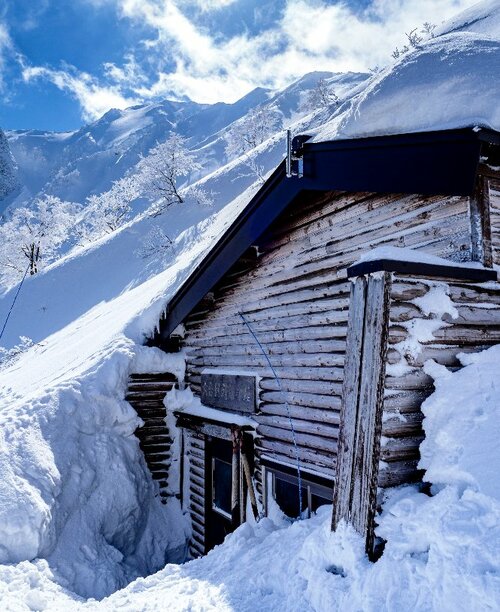 包まれる　雪の斜面にすっぽり包まれそうな６合目避難小屋