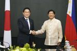 　３日、会談前にフィリピンのマルコス大統領（右）と握手する岸田首相＝マニラ（共同）