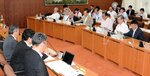 県議会常任委員らに回答する内閣府の職員（左側）＝１３日、鳥取県庁