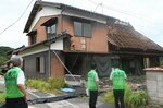  突風でトタン屋根が大きくはがれた民家を調査する鳥取地方気象台の職員ら＝２８日、鳥取県伯耆町立岩 