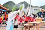 熱した湯を振り上げて邪気をはらった御釜清め神事＝１５日、新温泉町の浜坂県民サンビーチ