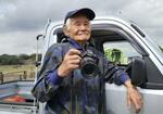 　カメラを持つ花井節二さん＝２０２２年３月、奈良県明日香村