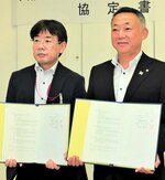 協定書に署名した中田村長（右）と縄田店長＝９日、日吉津村役場