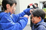 【上から下へ】経験豊富な上のお兄さんたちが低学年の墨塗りを担当。伝統をつなぐ