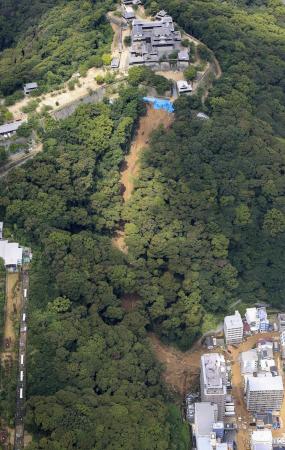 　松山城（上）がある山の社面で発生した土砂崩れ現場＝１２日、松山市