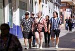 　３月、スペイン南部ロンダで高い気温となり、半袖シャツや短パン姿で街中を歩く観光客（ロイター＝共同）