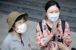 　救助後、台湾の人々に感謝して手を合わせる娘（右）と母親の日本人親子＝５日、台湾東部・花蓮（共同）