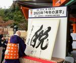 　２０２３年の世相を１字で表す「今年の漢字」が「税」に決まり、京都・清水寺で森清範貫主が力強く揮毫した＝１２日午後、京都市東山区