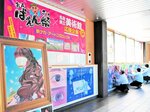 駅構内の自由通路に作品を展示する実行委員ら＝１８日、ＪＲ倉吉駅