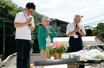 　津久井やまゆり園の「鎮魂のモニュメント」に献花し、手を合わせる元職員の太田顕さん（右）ら＝２６日午前、相模原市