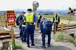 　小学４年の女児が死亡した踏切事故現場を調査する運輸安全委員会の鉄道事故調査官ら＝７日午前、群馬県高崎市