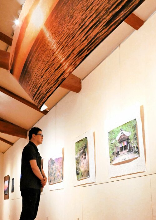 和紙に印刷された写真や、巨大タペストリーが並ぶ＝鳥取市青谷町山根のあおや和紙工房