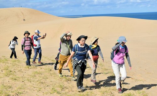 秋風を受けて鳥取砂丘を歩く参加者＝５日、鳥取市福部町湯山の鳥取砂丘