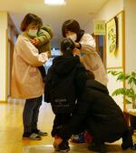 　一時預かりを再開した石川県輪島市の「かわい保育園」で、園児を迎える職員＝２２日午前