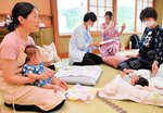 子どもたちの面倒を見るスタッフら。参加者はゆっくりと入浴や食事を楽しんだ＝２６日、新温泉町湯の「湯村温泉　とみや」