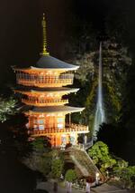 　試験点灯が行われた「那智の滝」と青岸渡寺の「三重塔」＝１９日夜、和歌山県那智勝浦町