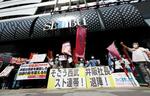 　西武池袋本店前でストライキを支持し、シュプレヒコールを上げる人たち＝３１日午前、東京都豊島区